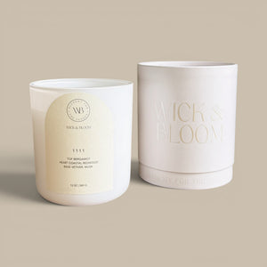 Wick & Bloom 11 11 candle shown with cream box, white matte vessel with arched cream label