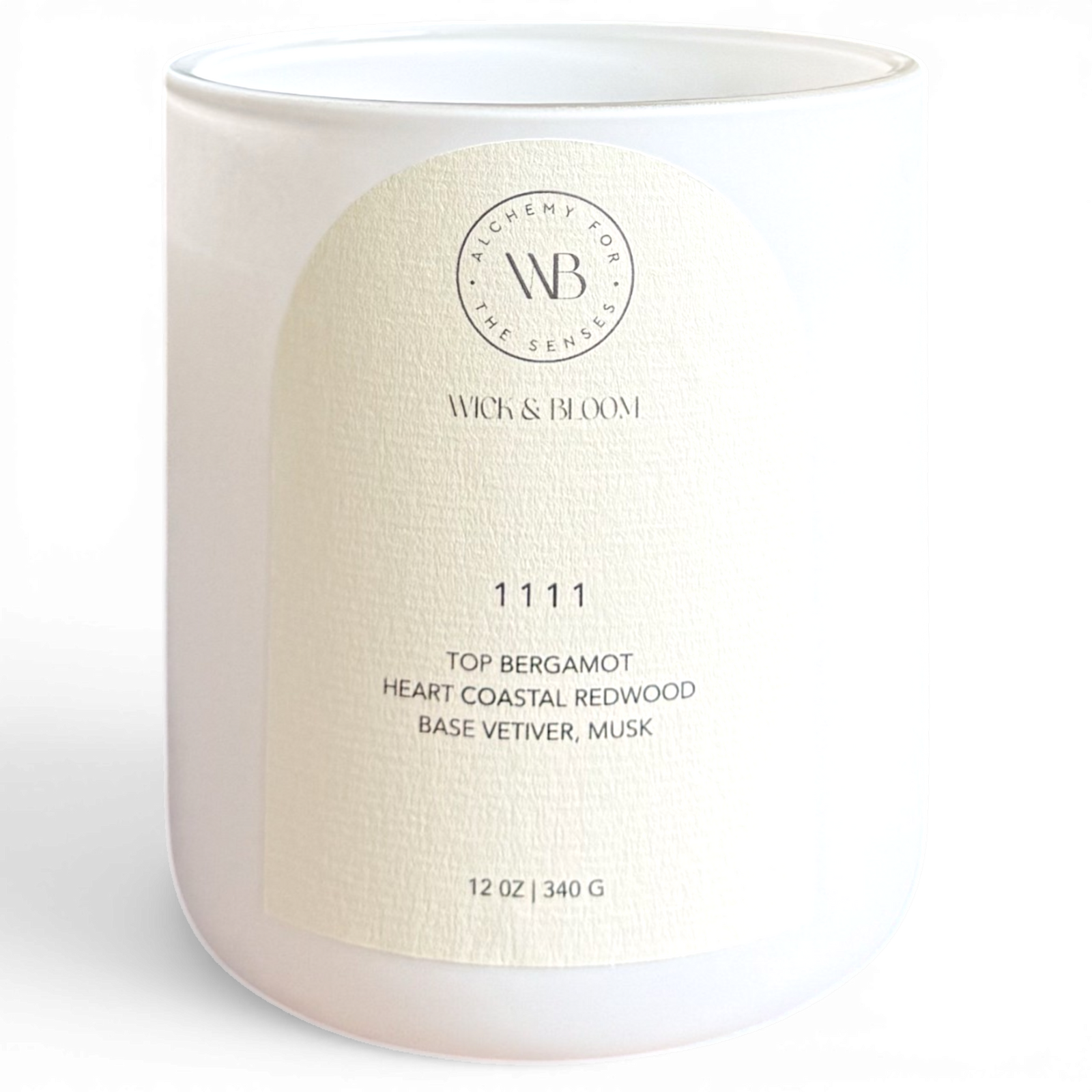 Wick & Bloom 11 11 wood wick candle in white vessel, label showing bergamot, redwood, vetiver and musk notes