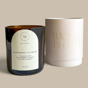 Wick & Bloom Cardamom Cashmere candle beside its cream Wick & Bloom gift box