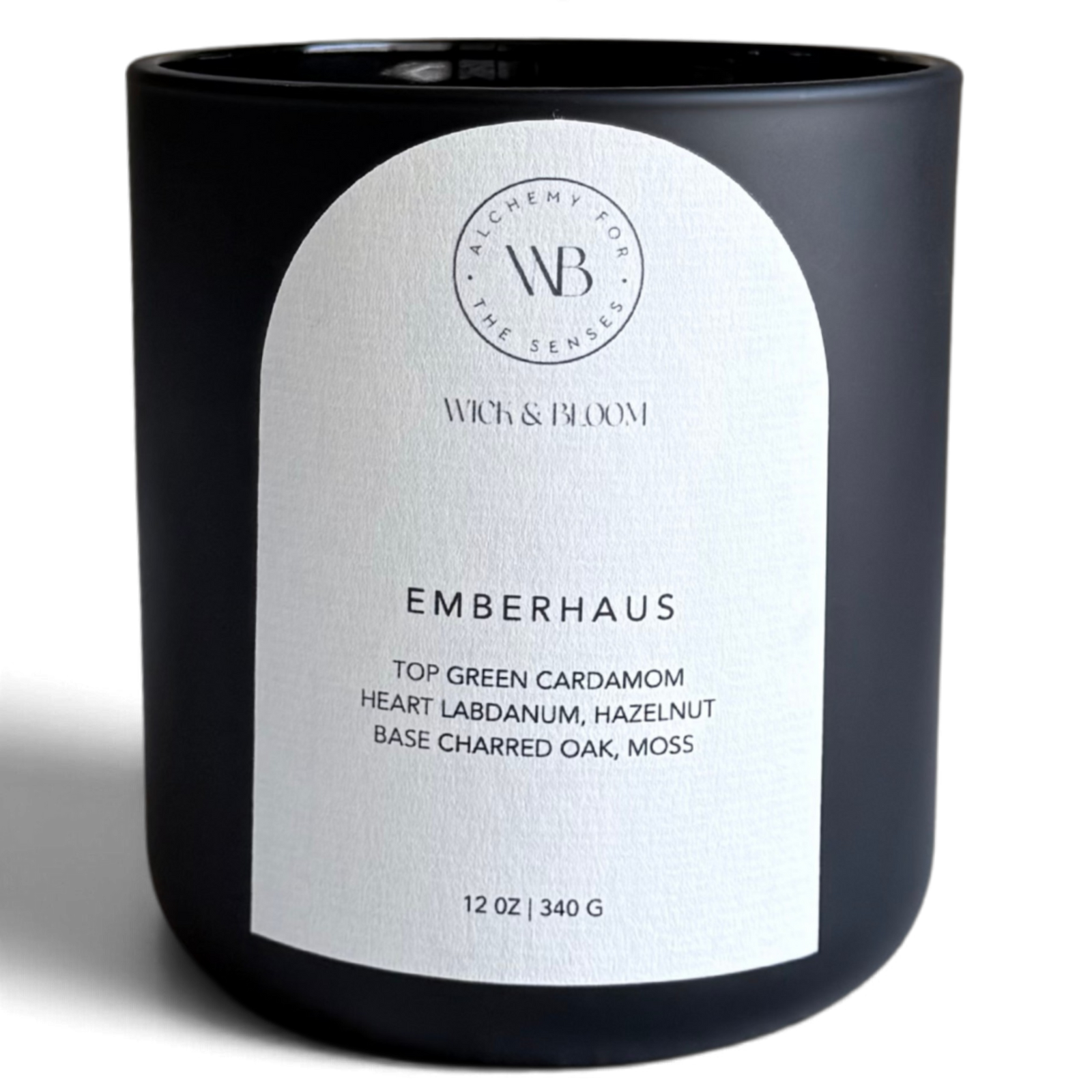 Wick & Bloom Emberhaus candle with green cardamom, charred oak and moss in a matte black vessel