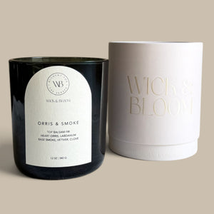Wick & Bloom Orris & Smoke candle beside its cream Wick & Bloom gift box